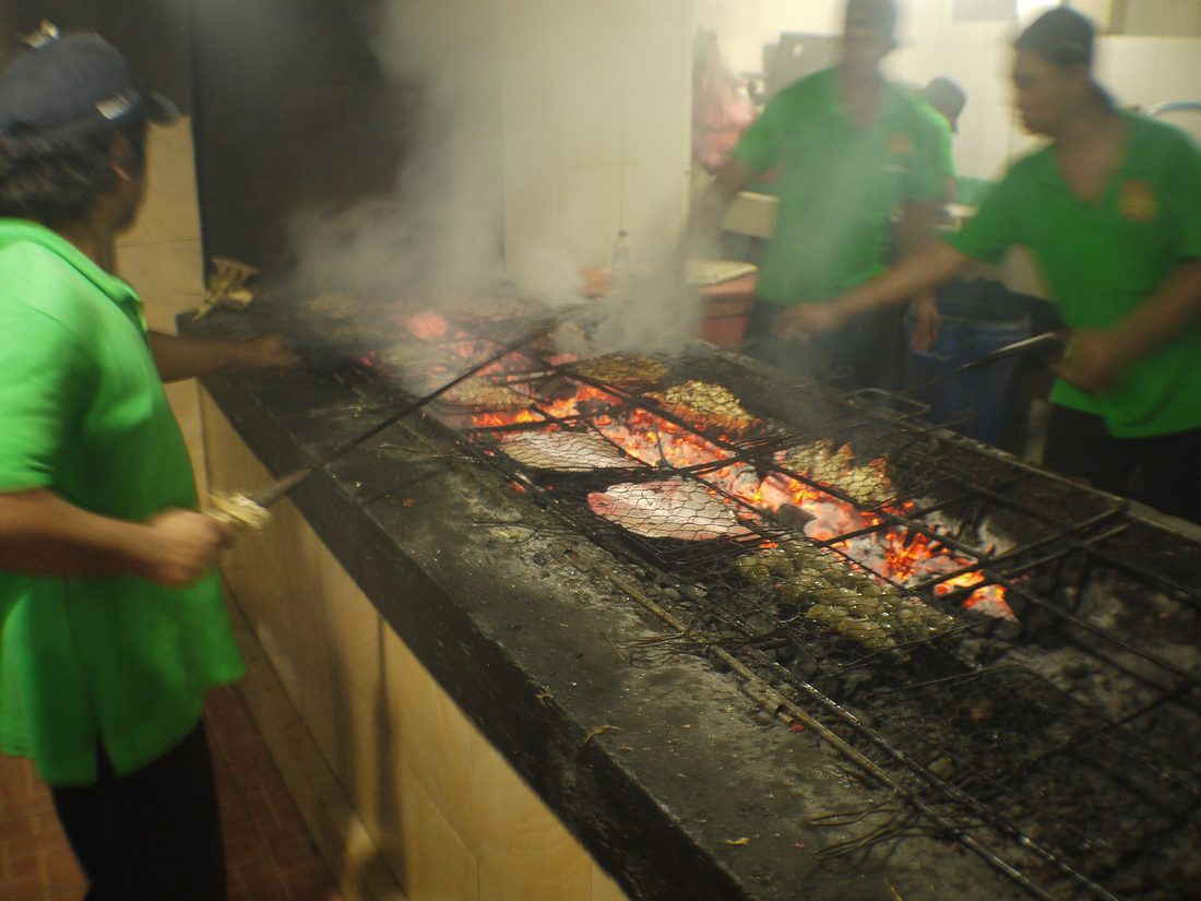 Fish grilling over charcoal at Jimbaran